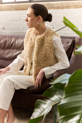 Model wearing Cream faux sheepskin gilet by Helen Moore