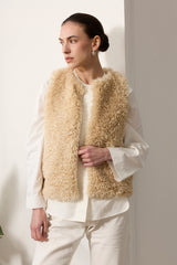 Model wearing Cream faux sheepskin gilet by Helen Moore