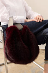Model carrying the Wine faux fur Slouch bag by Helen Moore