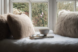 Faux fur rectangular cushions by Helen Moore in shades of beige and grey