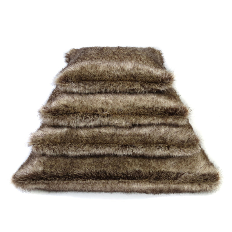 Stack of  brown faux fur cushions by Helen Moore