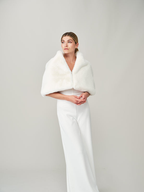 Model wearing the Ivory Cloud faux fur bridal cape by Helen Moore
