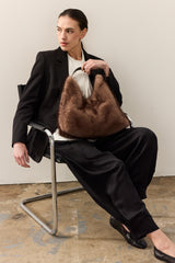Model holding the Ash Grey faux fur Peak Tote bag with leather handle by Helen Moore
