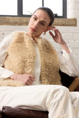 Model wearing Cream faux sheepskin gilet by Helen Moore