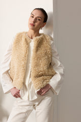 Model wearing Cream faux sheepskin gilet by Helen Moore