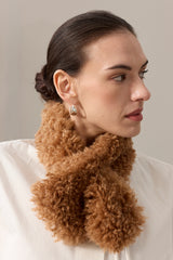 Model wearing a faux sheepskin Tiptop Scarf in Teddy brown by Helen Moore