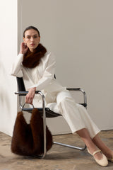 Model holding the Mahogany faux fur Peak Tote bag with leather handle by Helen Moore