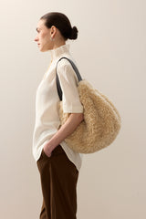 Model carrying the faux fur Slouch bag in Cream faux sheepskin by Helen Moore