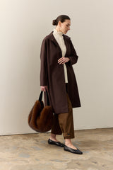 Model carrying the faux fur Slouch bag in Mahogany Brown by Helen Moore