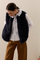 Model wearing Navy  faux sheepskin gilet by Helen Moore