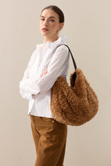 Model carrying the Teddy faux sheepskin Slouch bag by Helen Moore