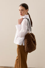 Model holding the chestnut faux sheepskin Barrel Tote Bag by Helen Moore