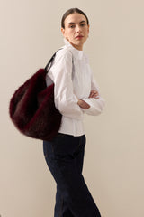 Model carrying the Wine faux fur  Slouch bag by Helen Moore