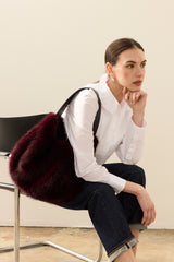 Model carrying the Wine faux fur  Slouch bag by Helen Moore