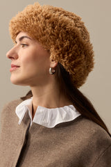Model wearing a mid brown faux sheepskin Sherpa Hat by Helen Moore