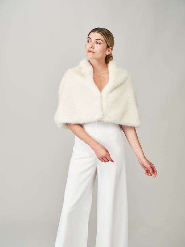 Model wearing the Ermine Cream faux fur bridal cape by Helen Moore