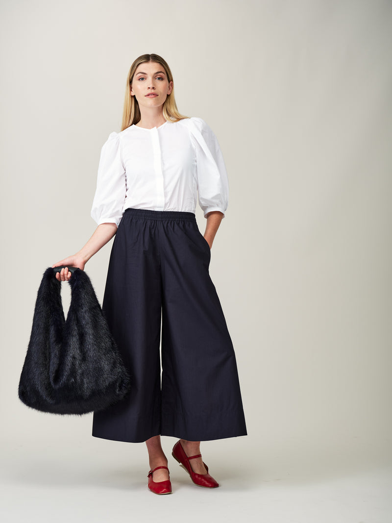 Model carrying the Midnight blue faux fur Triangle Bag by Helen Moore