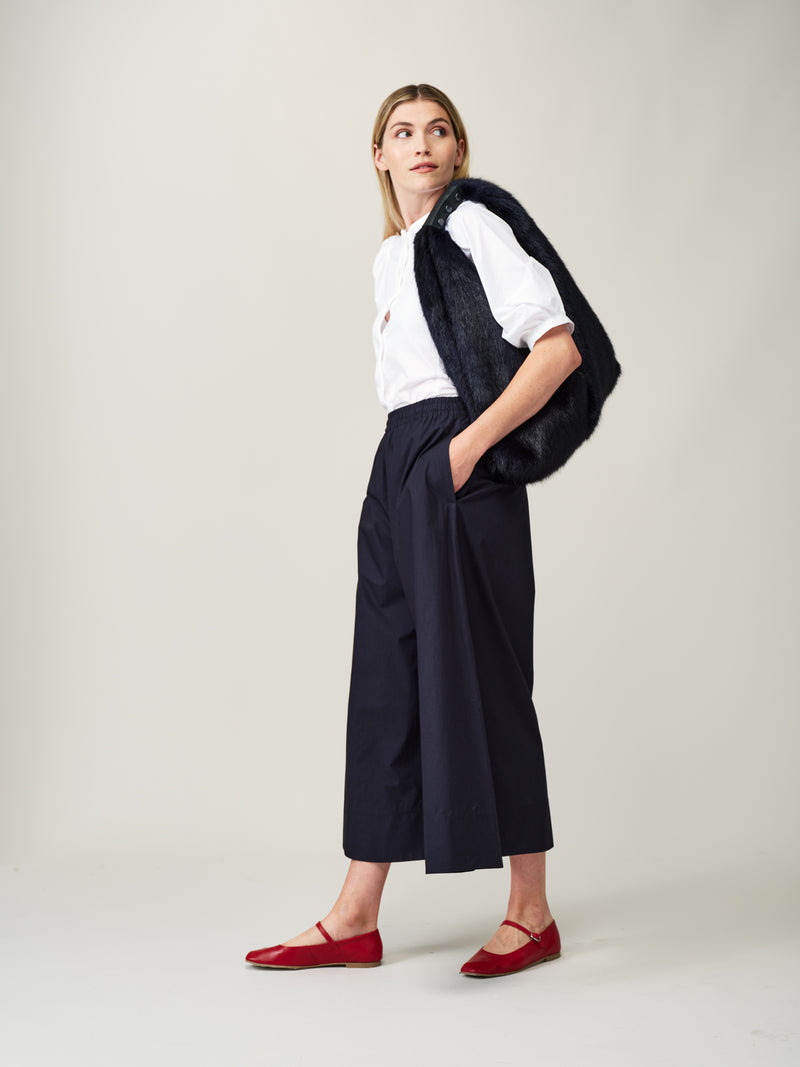 Model carrying the Midnight blue faux fur Triangle Bag by Helen Moore