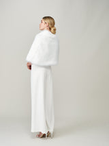 Model wearing the Whisper White faux fur bridal cape by Helen Moore