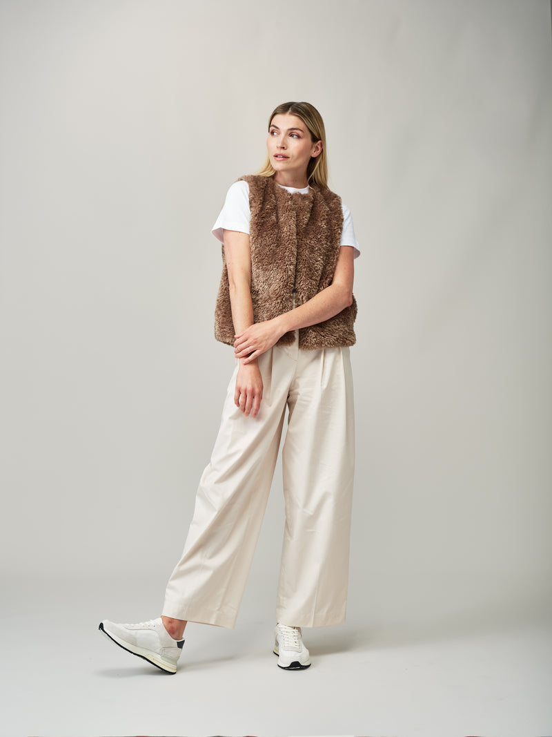 Model wearing a Taupe faux sheepskin gilet by Helen Moore