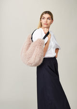 Model holding the Quartz faux fur Slouch Bag by Helen Moore