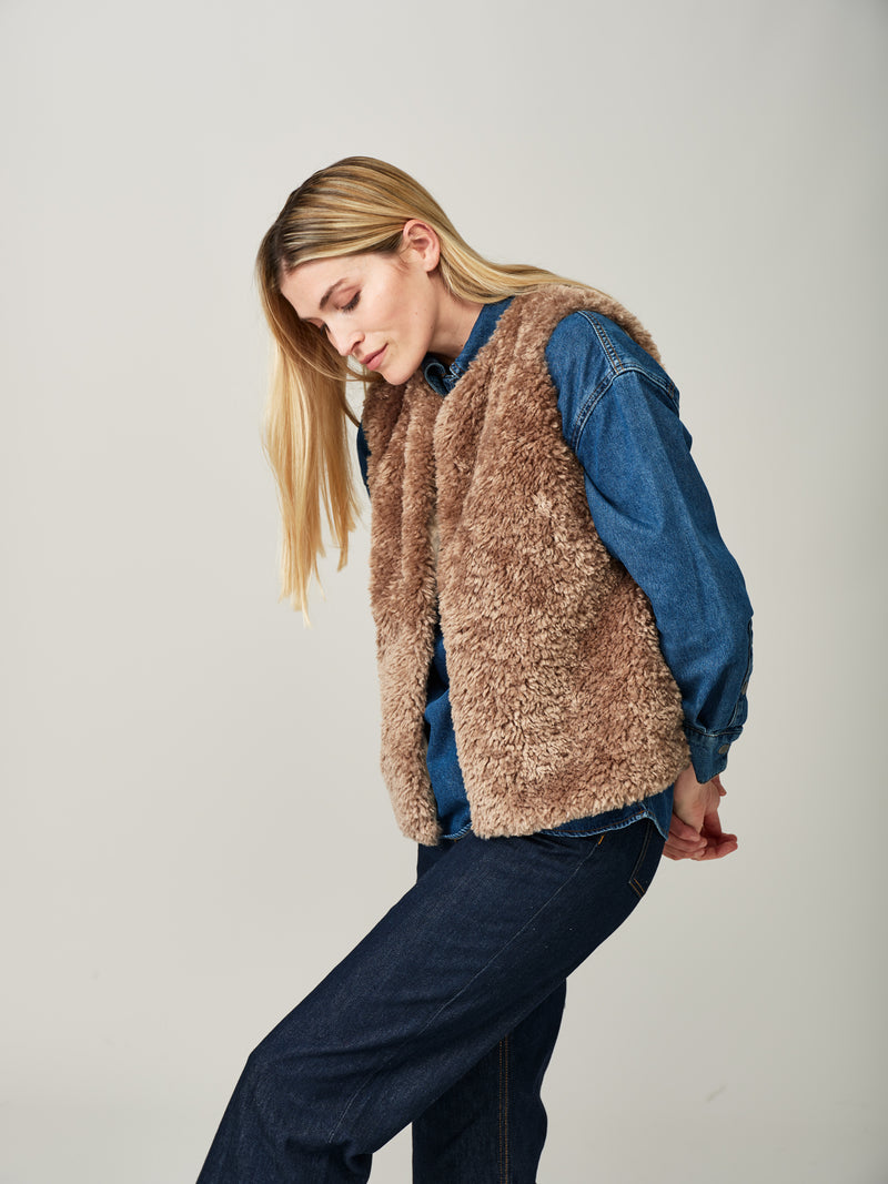 Model wearing a Taupe faux sheepskin gilet by Helen Moore