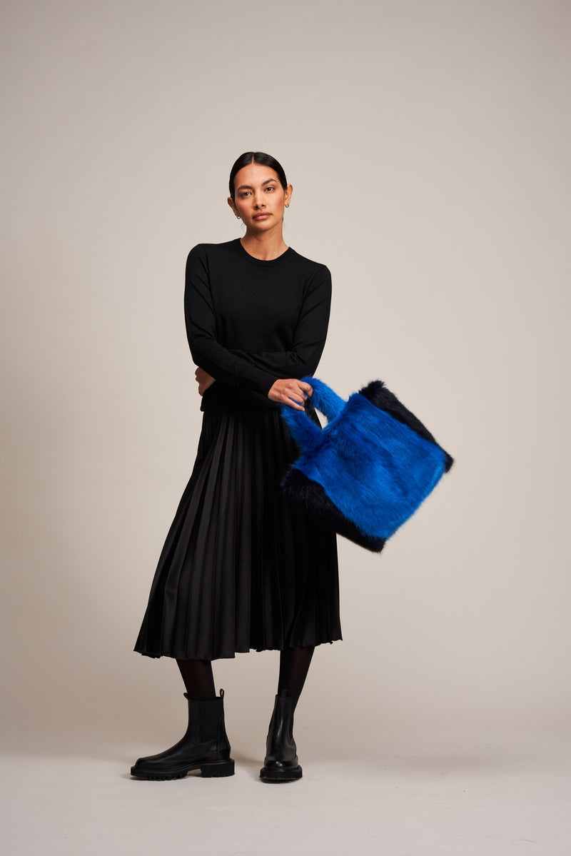 Model carrying the Royal Blue and Midnight Blue faux fur Joy bag by Helen Moore.