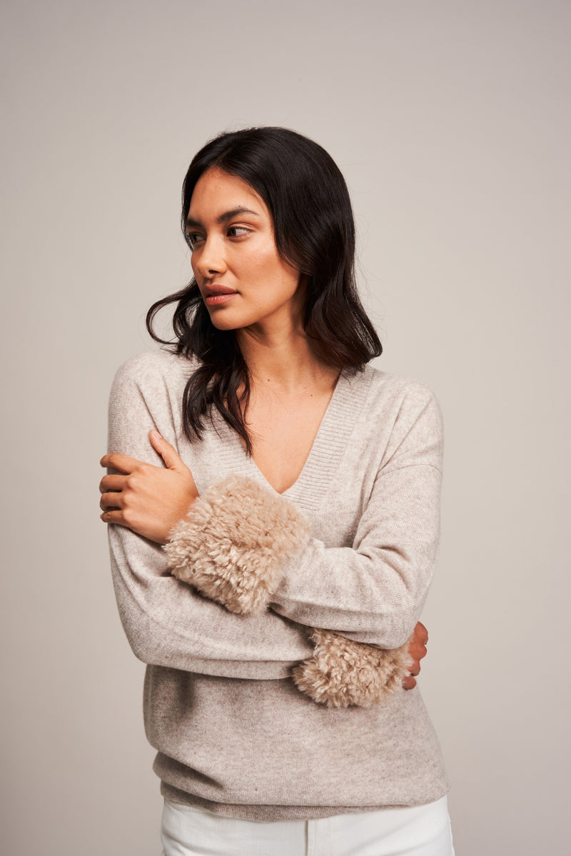 Model wearing Pebble faux sheepskin wrist warmer cuffs by Helen Moore