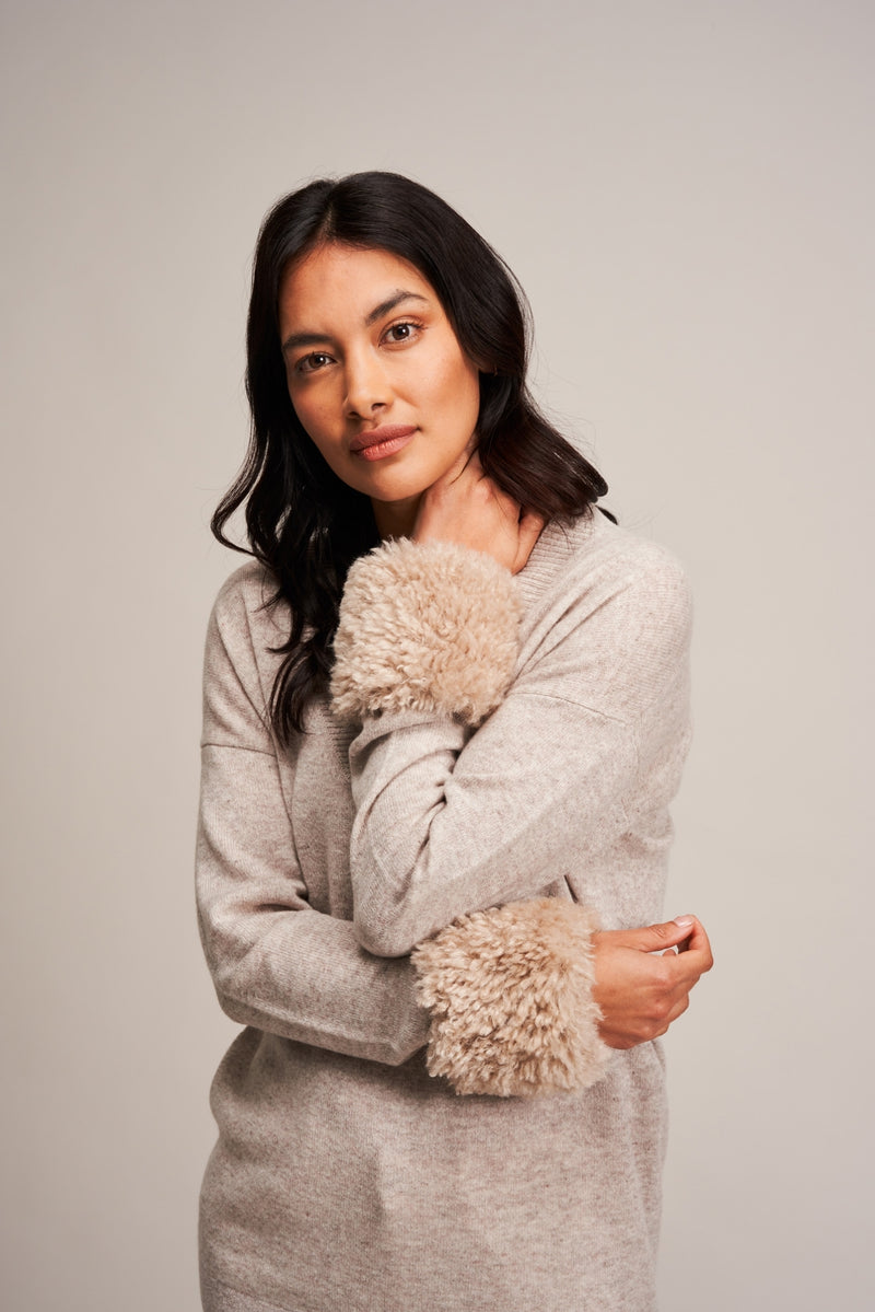 Model wearing Pebble faux sheepskin wrist warmer cuffs by Helen Moore