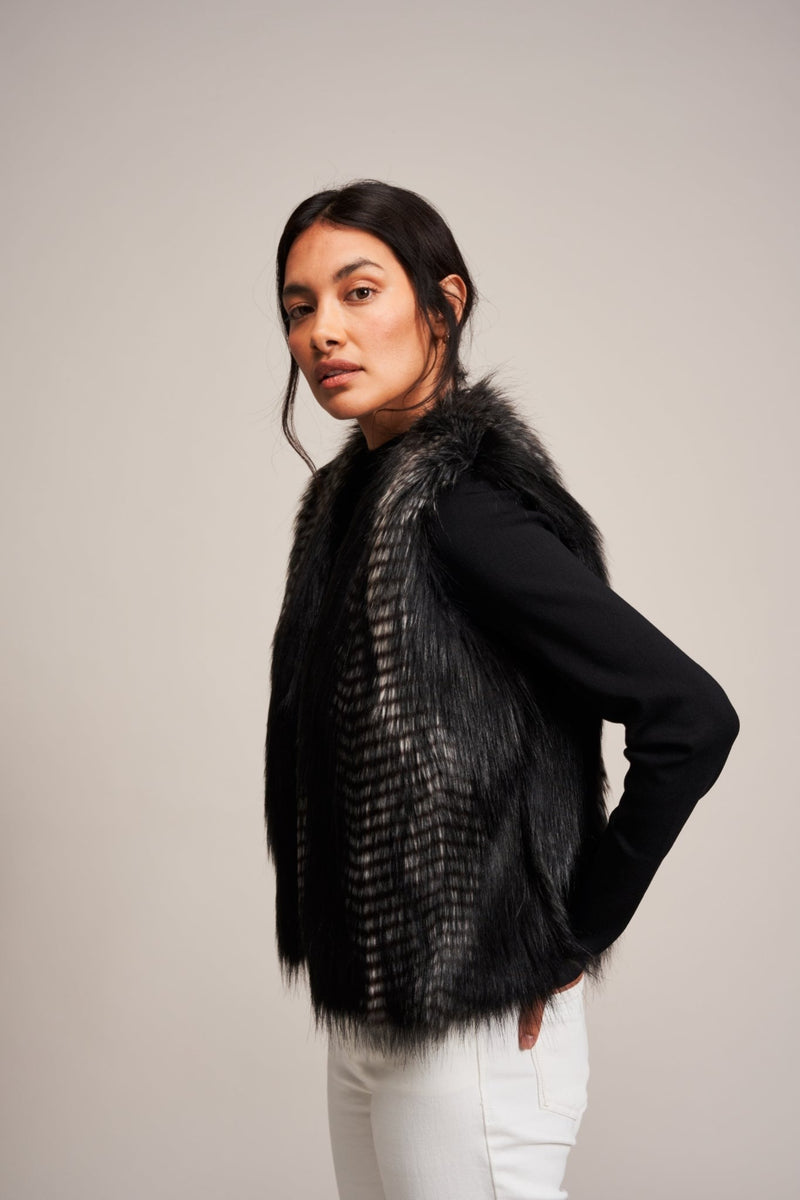 Model wearing a faux fur gilet in Black Quail by Helen Moore