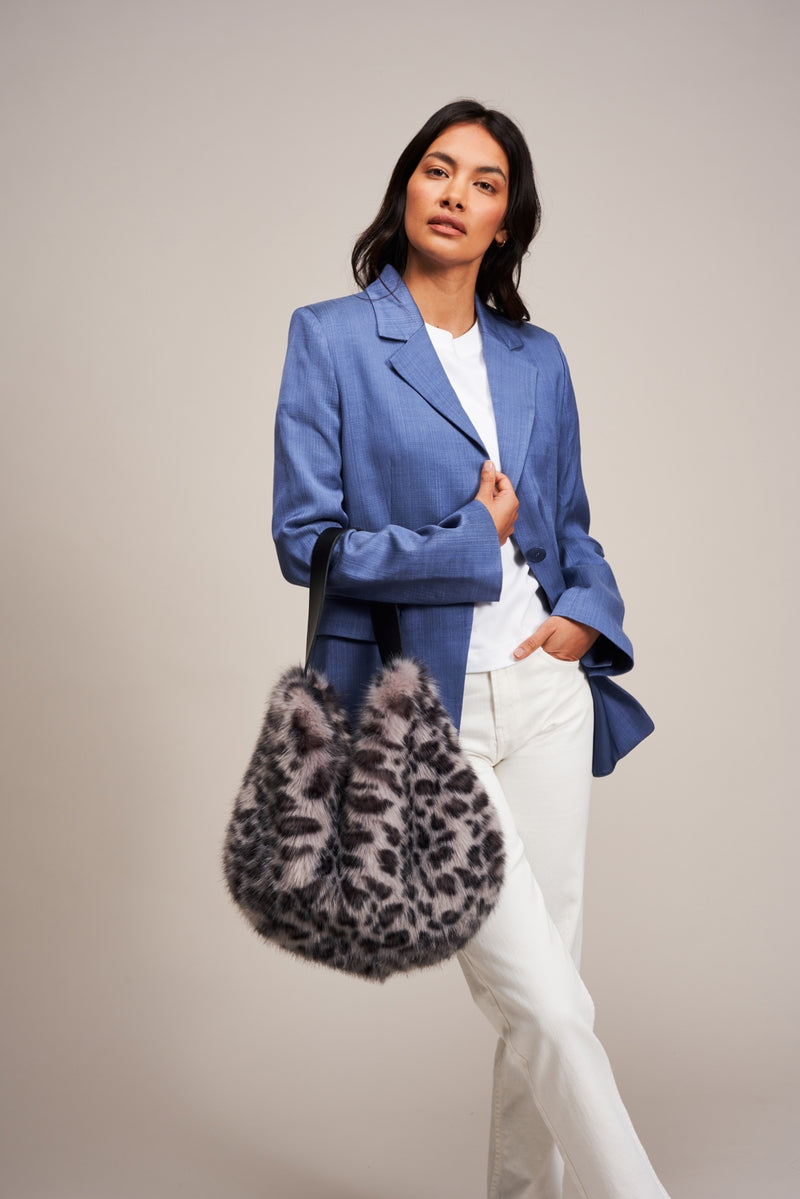 Model carrying a faux fur slouch bag in Silver Leopard animal print by Helen Moore