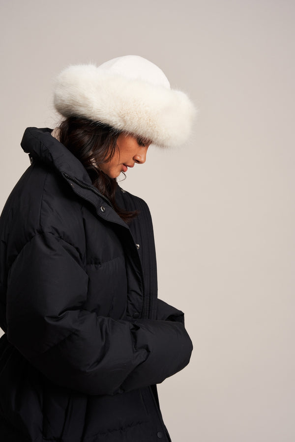 Model wearing an Ermine white faux fur Brim Hat by Helen Moore