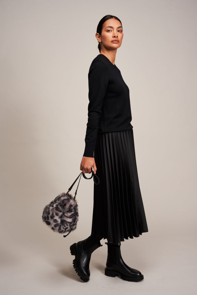 Model carrying a faux fur drawstring bag in Silver Leopard animal print by Helen Moore
