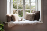 Faux fur rectangular cushions by Helen Moore in shades of beige and grey