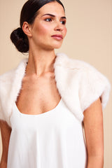 Model wearing cream white faux fur bolero by Helen Moore called Ermine