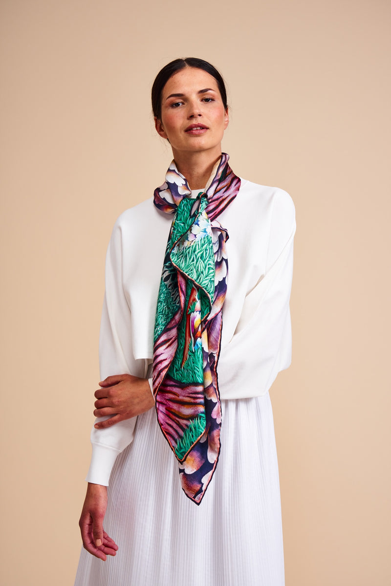 Model wearing a silk scarf featuring a painting by Stanley Moore entitled Swans.