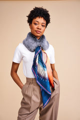 Model wearing a faux fur collar by Helen Moore with a silk Scarf featuring a painting by Stanley Moore entitled United Statement.