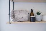 Beige faux fur make up bag by Helen Moore on a shelf