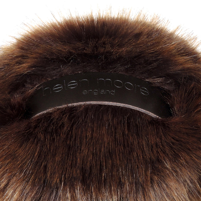 Close up of golden brown faux fur doorstop with leather handle by Helen Moore