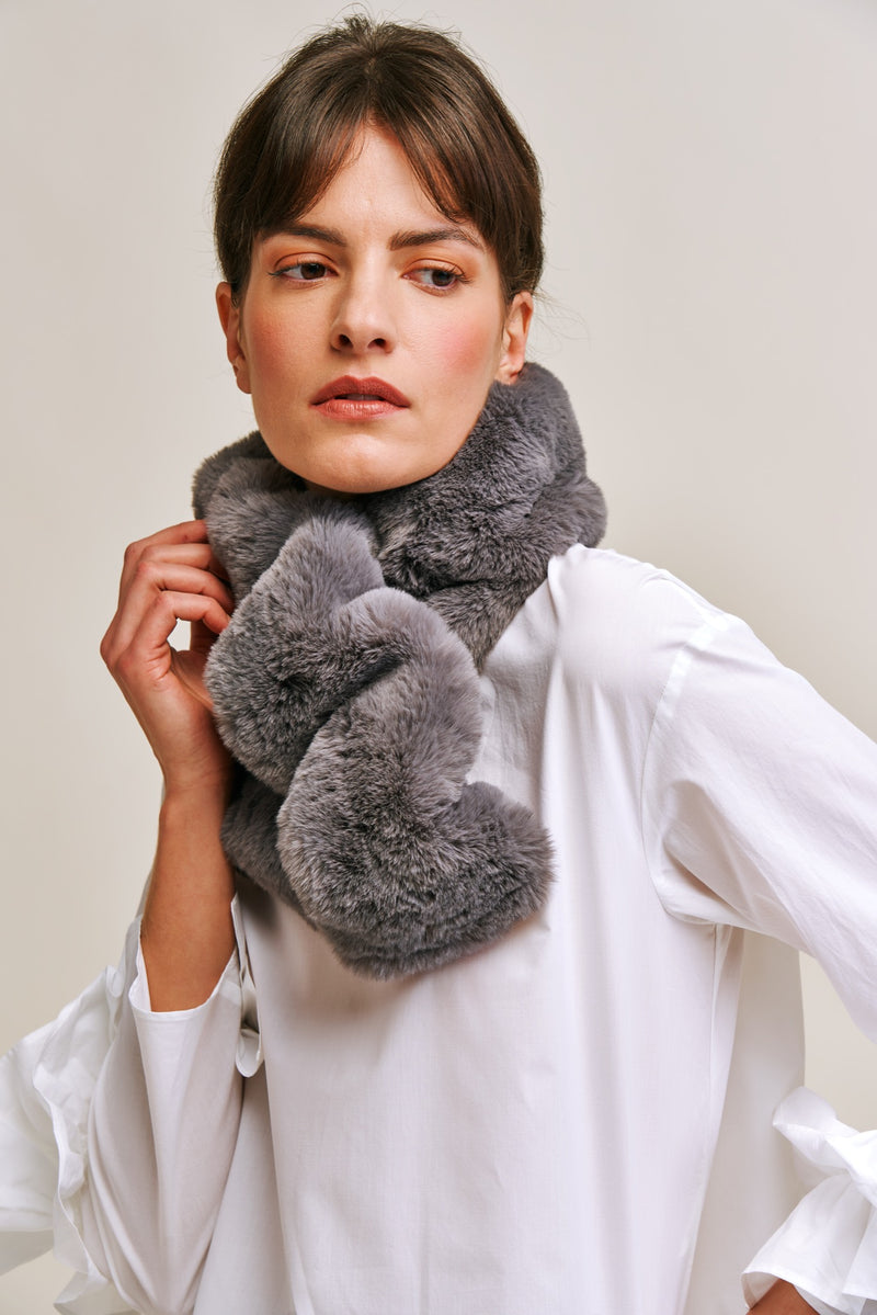 Model wearing a grey faux fur scarf which is gathered to create a ruffle effect. Made in England by Helen Moore